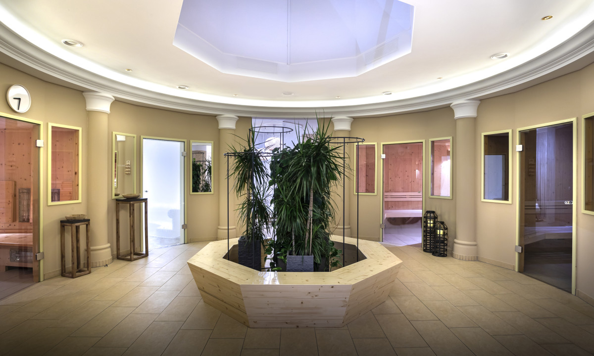 Central plant arrangement surrounded by doors and neutral-colored walls in a bright, modern interior at Valamar Obertauern Hotel