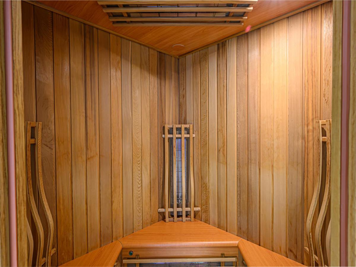 Wood-paneled sauna with built-in heaters, benches along walls at Ker Goh Lenn